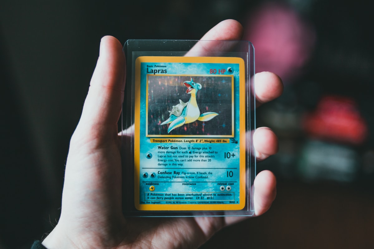 A vintage Pokemon card held in a protective toploader against a dark background