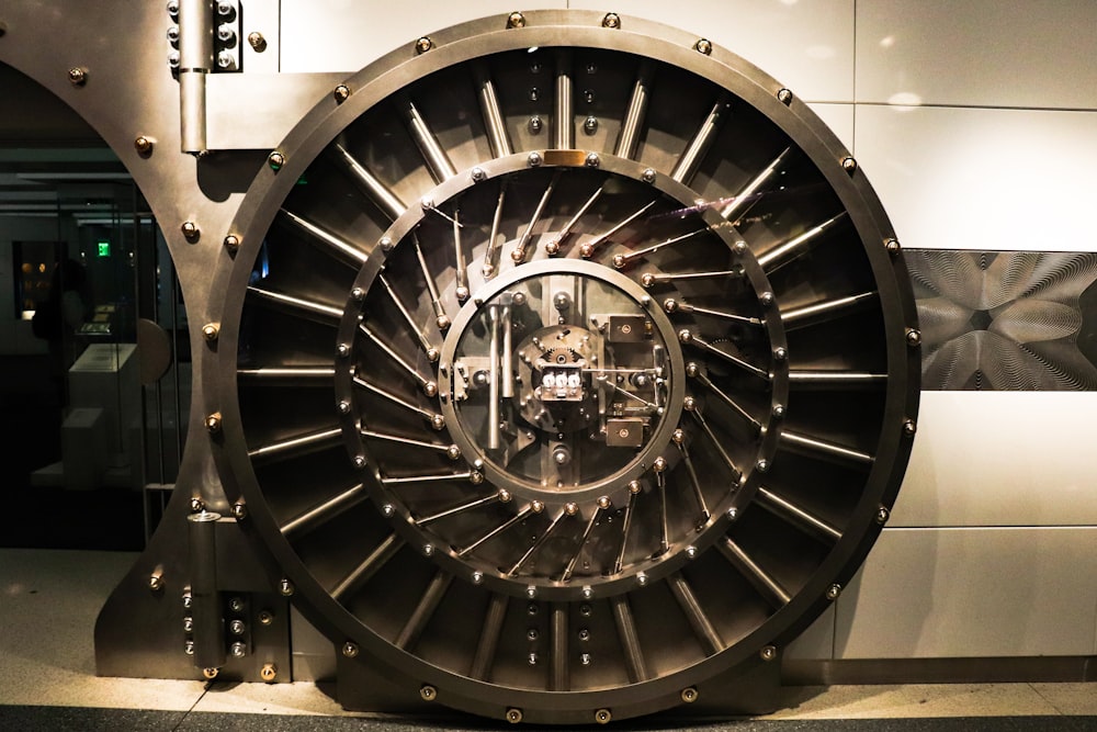 A round steel bank vault door, warmly lit